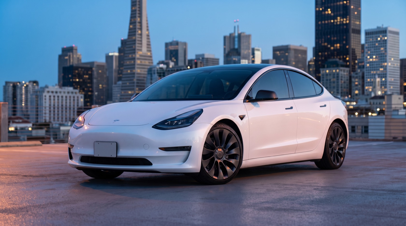 Snow, a white Tesla Model 3 Performance with dark wheels, on a San Francisco rooftop at dusk